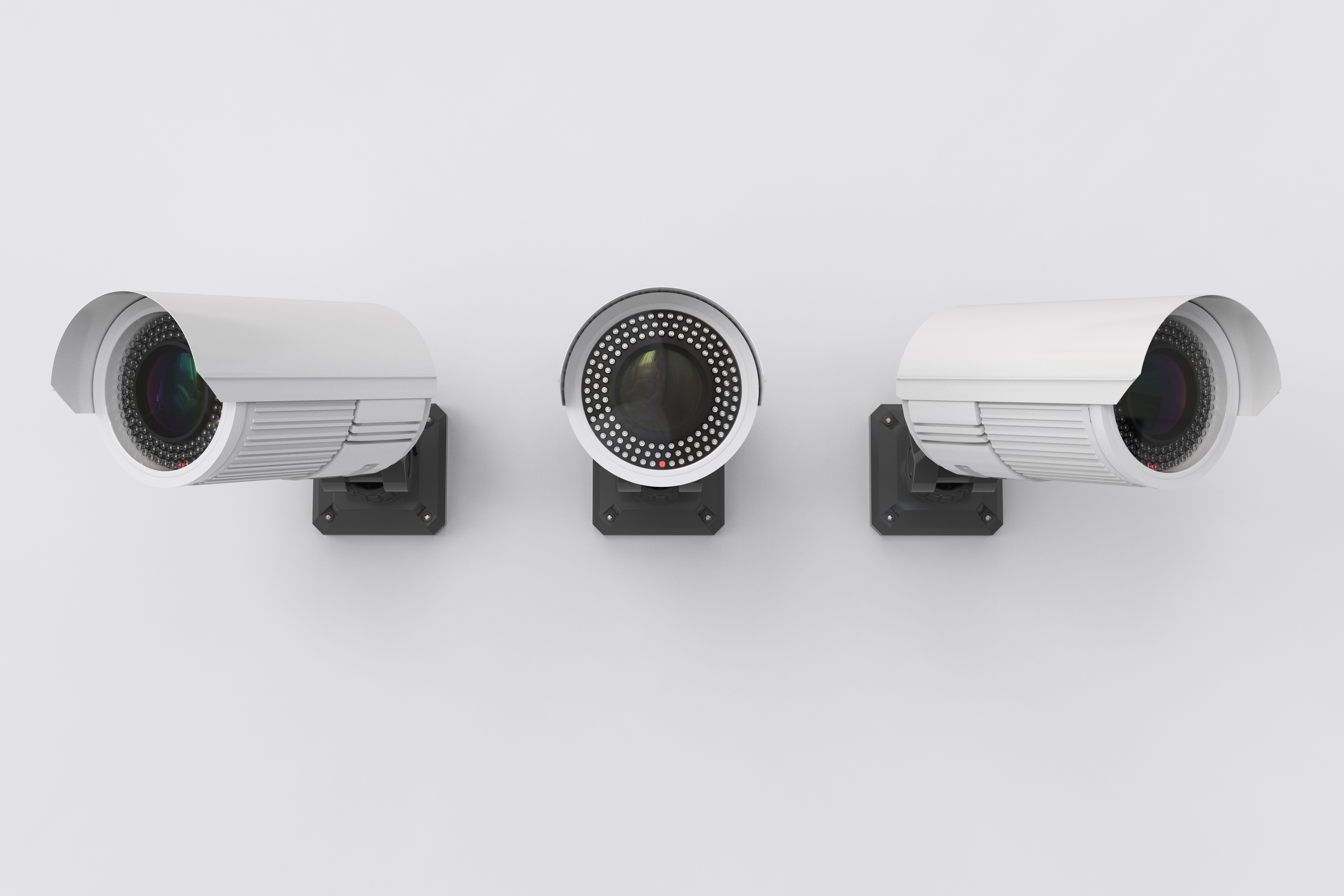 Commercial surveillance cameras on a clean wall